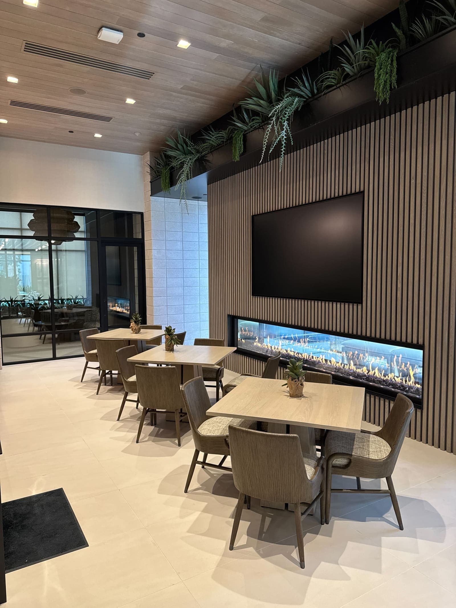 Commercial conference and lounge space with a large presentation display