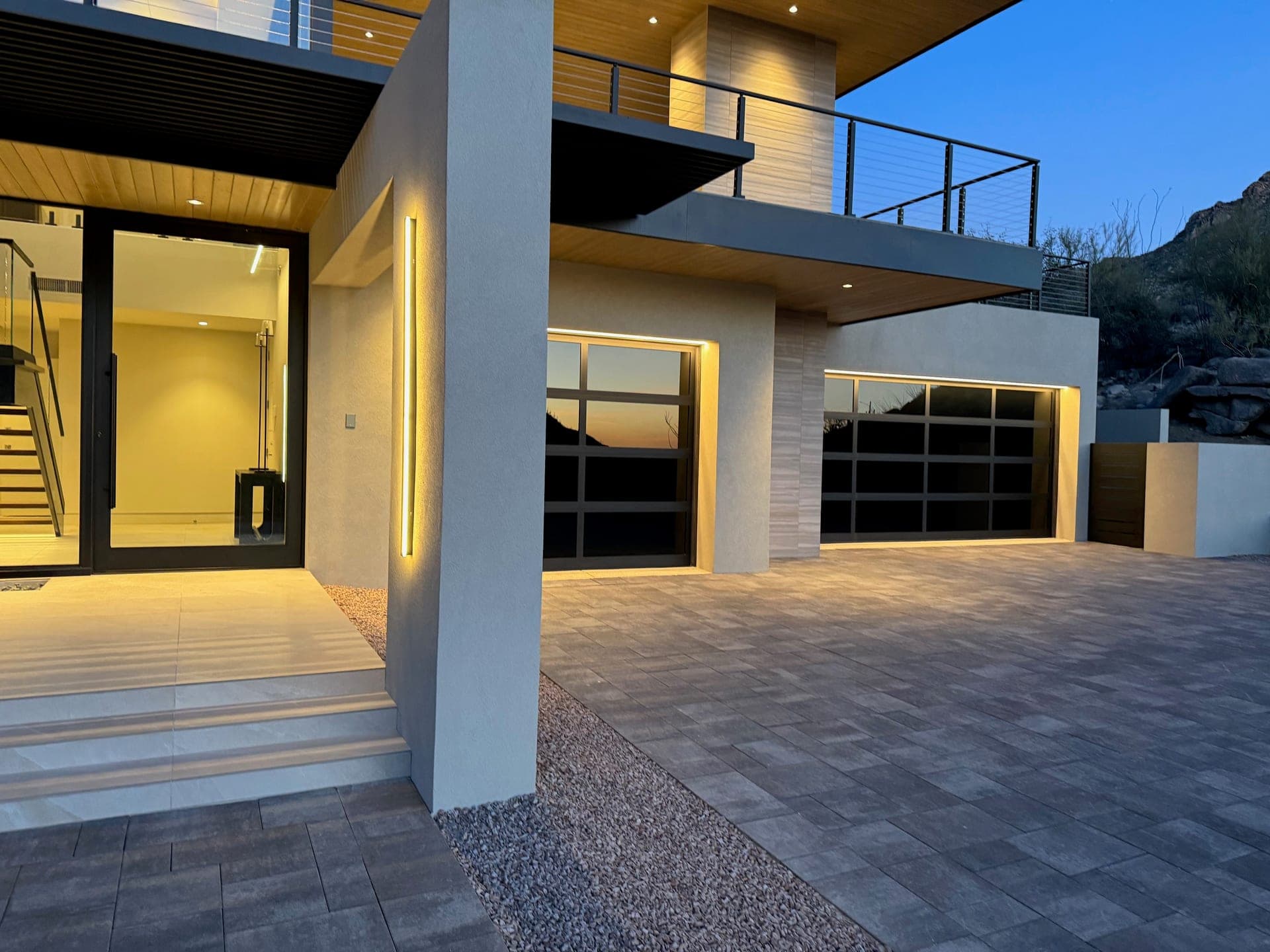 Modern Tucson home exterior at dusk lit with architectural facade lighting