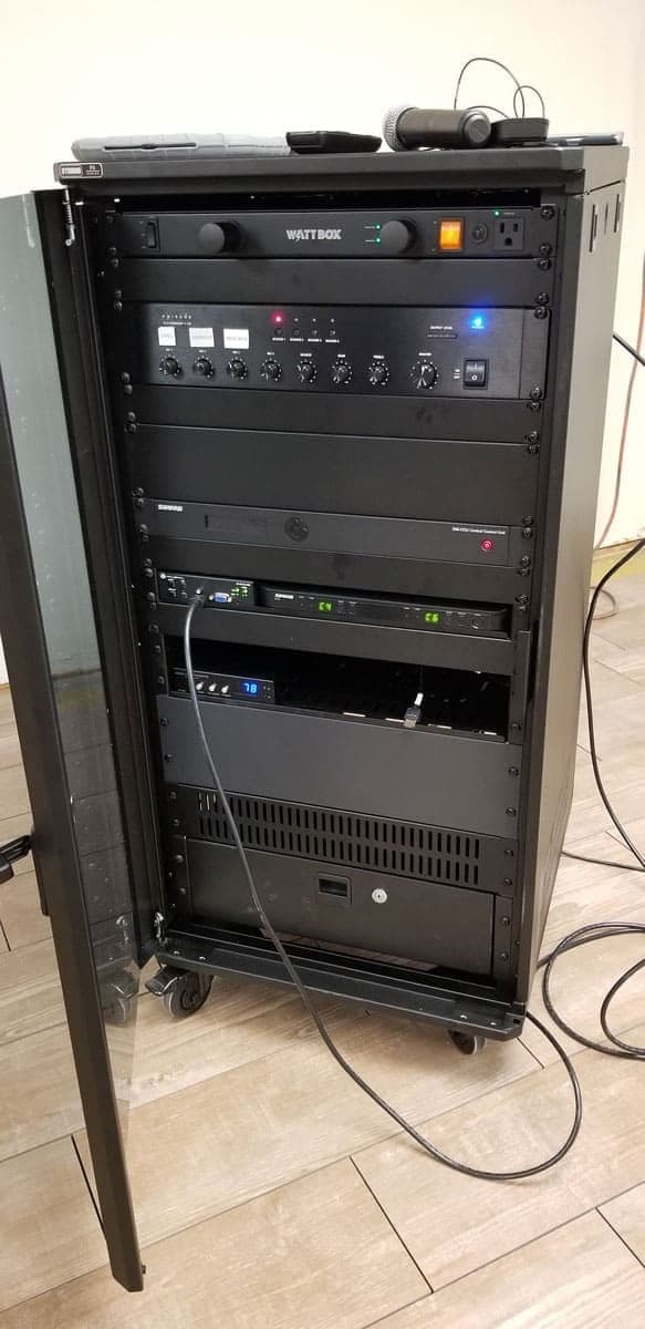 Freestanding AV rack housing amplifiers and video switching