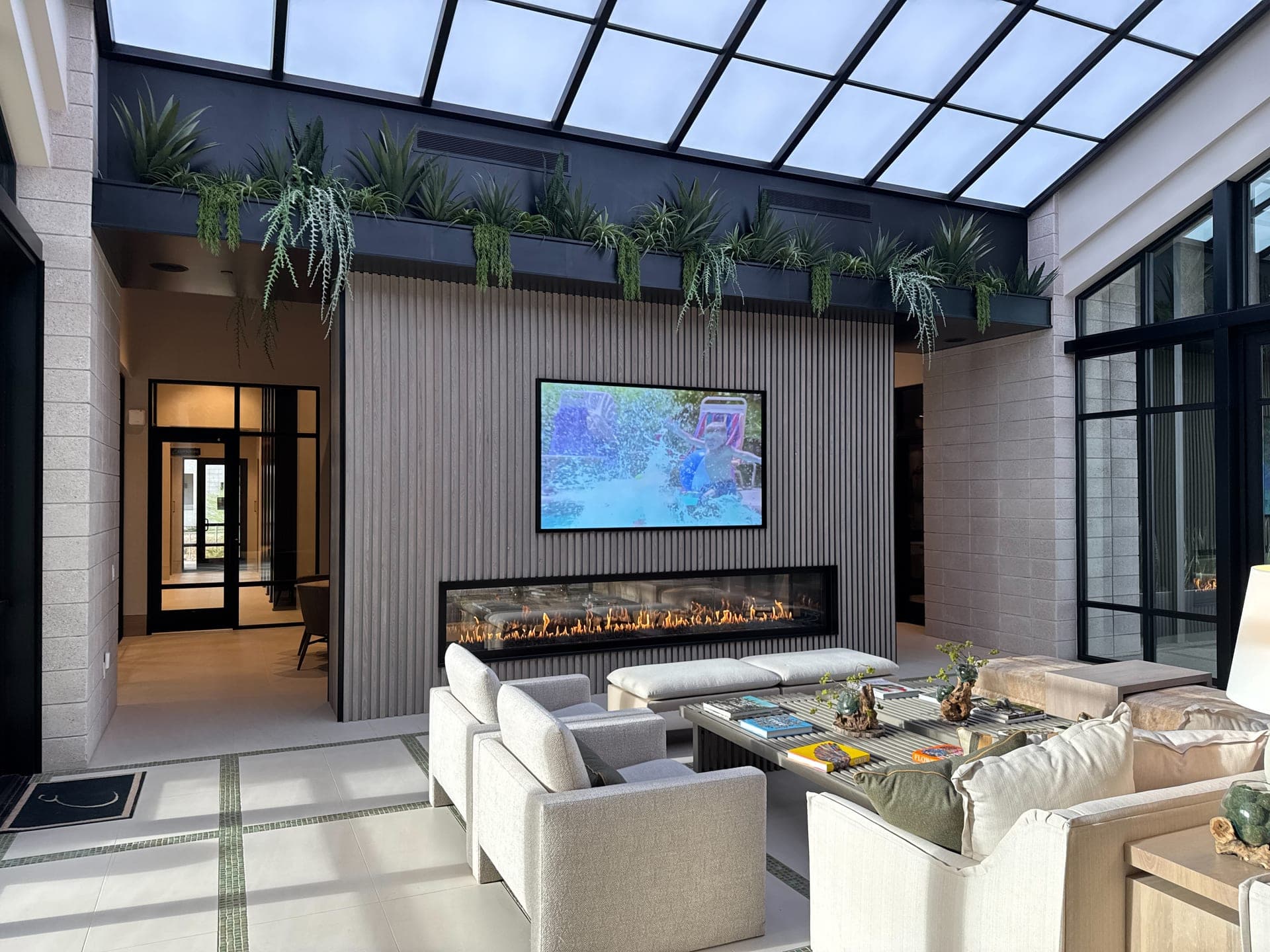 Modern Tucson great room with a linear fireplace and integrated flat-panel display