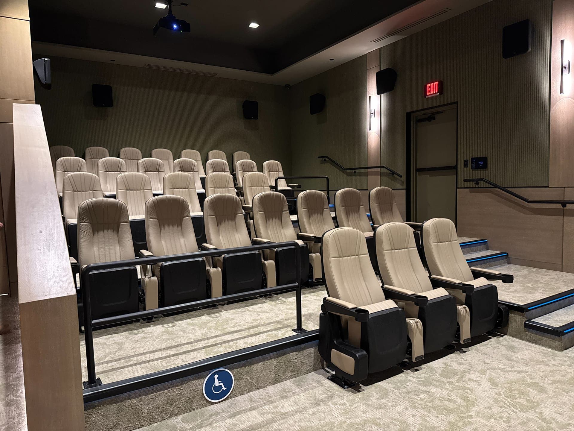 Private home theater in Tucson with tiered cream recliner seating and a wide projection screen
