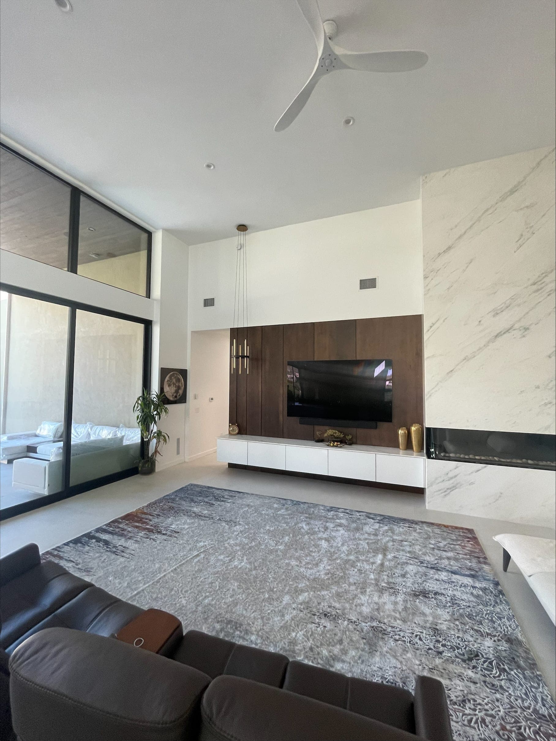 Living room with flush in-ceiling speakers and a wall-mounted display