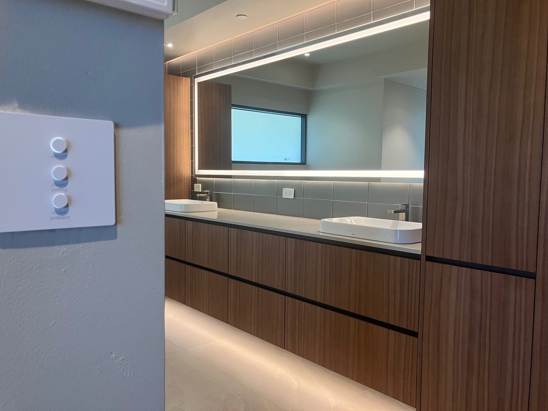 Wall-mounted lighting keypads controlling kitchen and under-cabinet lighting