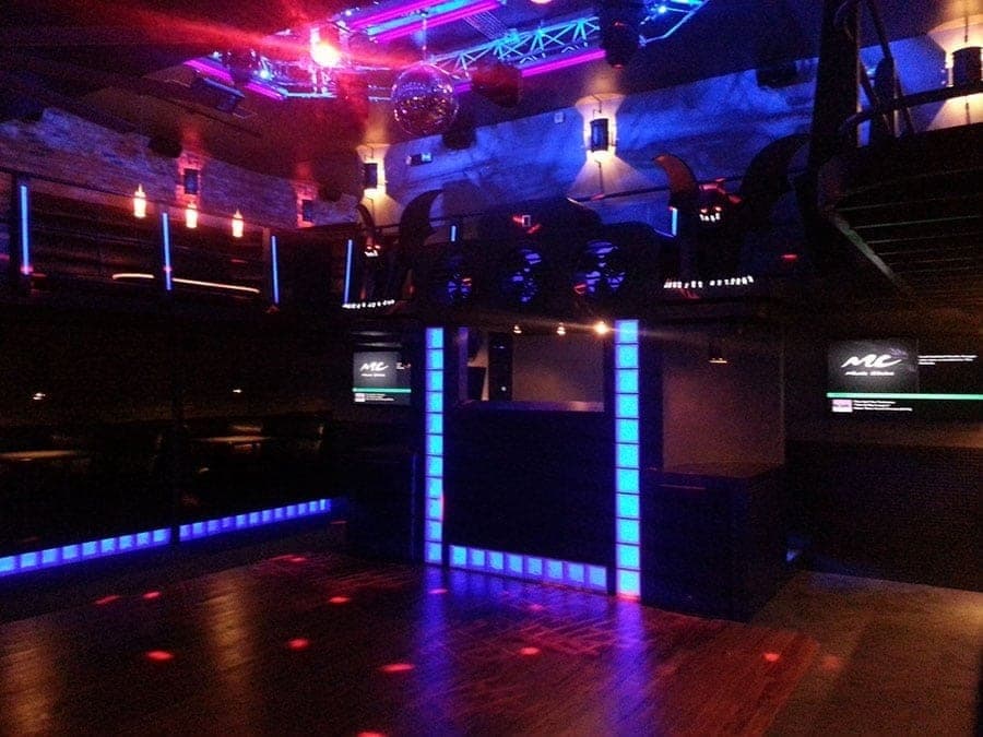 Nightclub stage lit with blue and magenta wash lighting