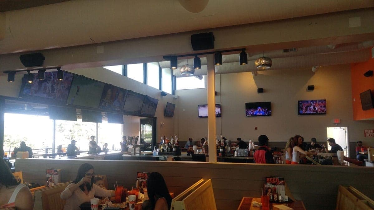 Restaurant dining room with distributed audio and multiple screens