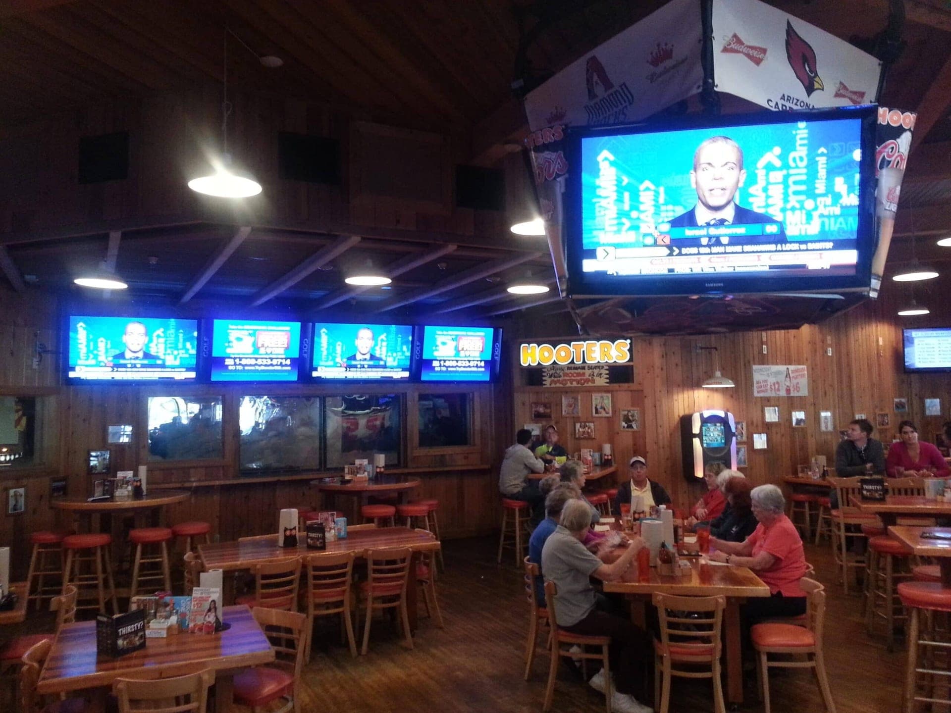 Sports bar with a bank of screens mounted above the bar