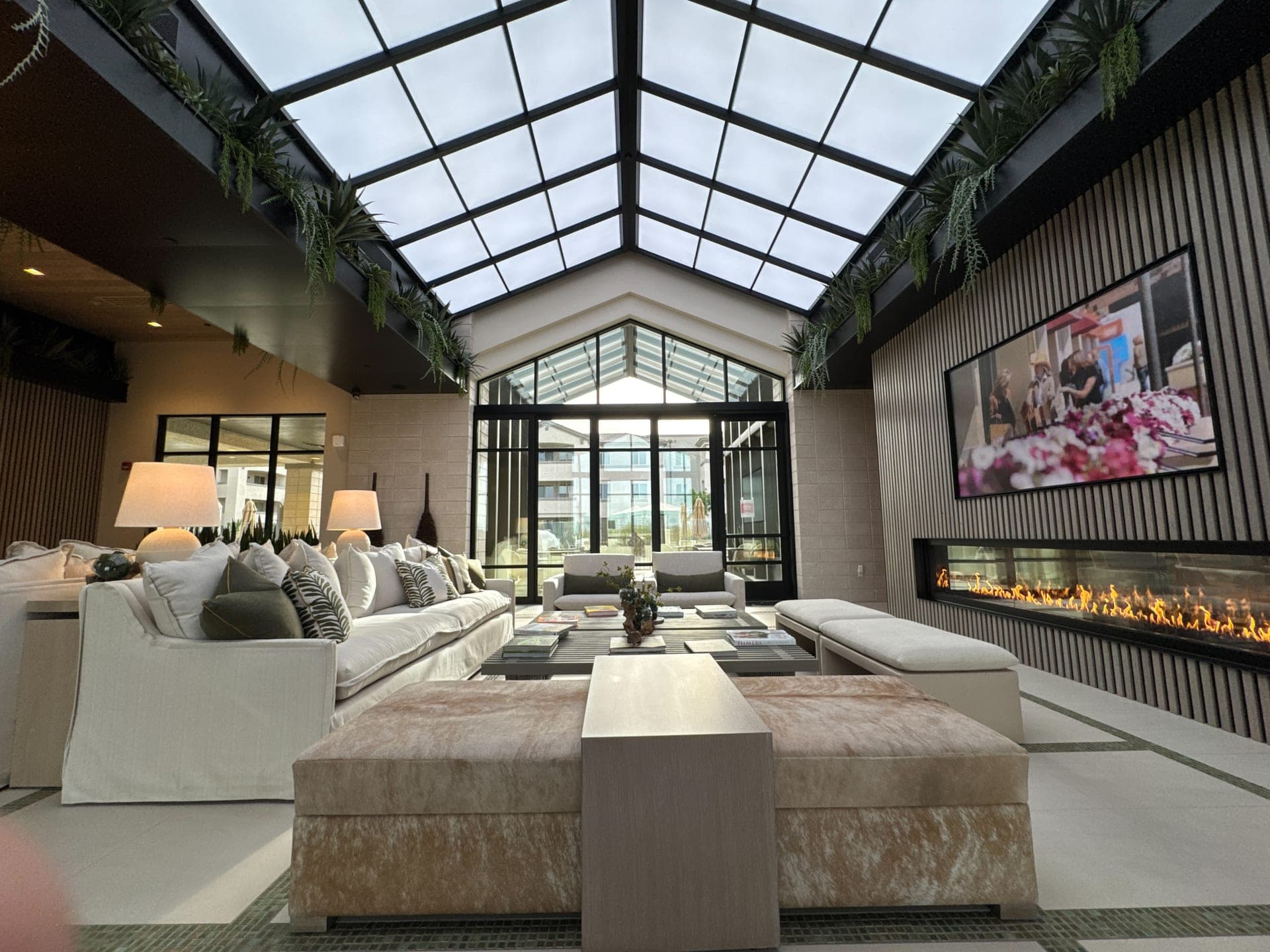 Vaulted great room with skylights, a large integrated display and concealed speakers